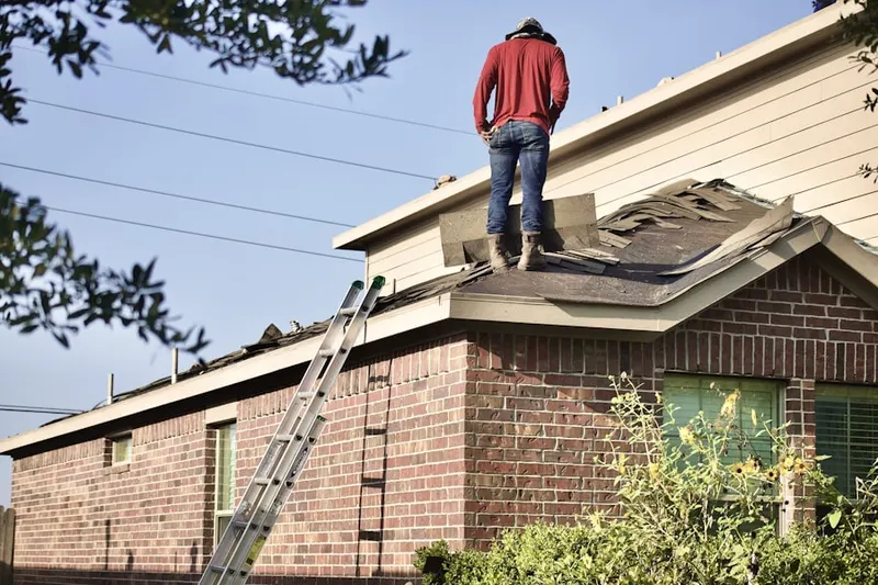 Professional roofer working on a residential roof in Woodland Hills